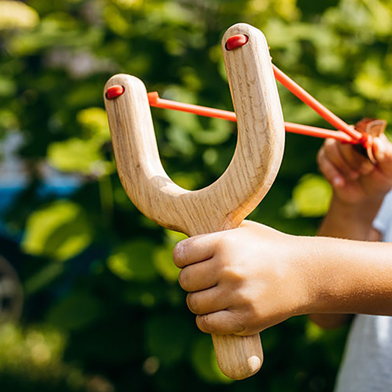 Close,Up,Wooden,Slingshot,Toy,In,Hands,Of,Little,Girl
