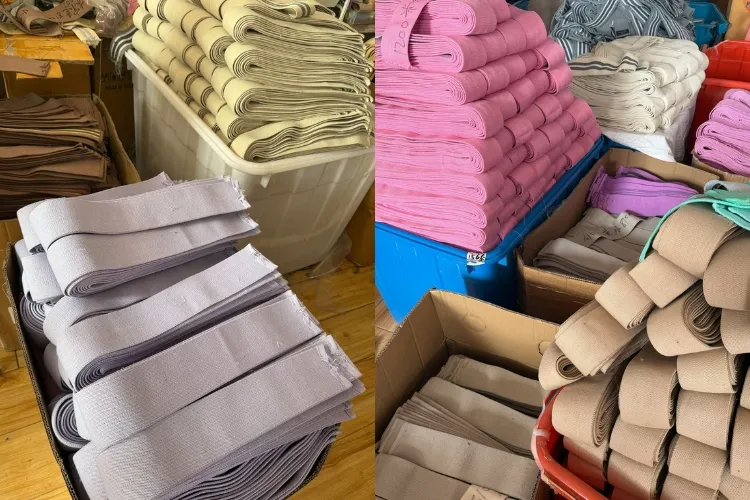 Custom fabric band loops factory production showing colorful bulk orders in pink, beige, purple and mint green at LBP Fitness workshop
